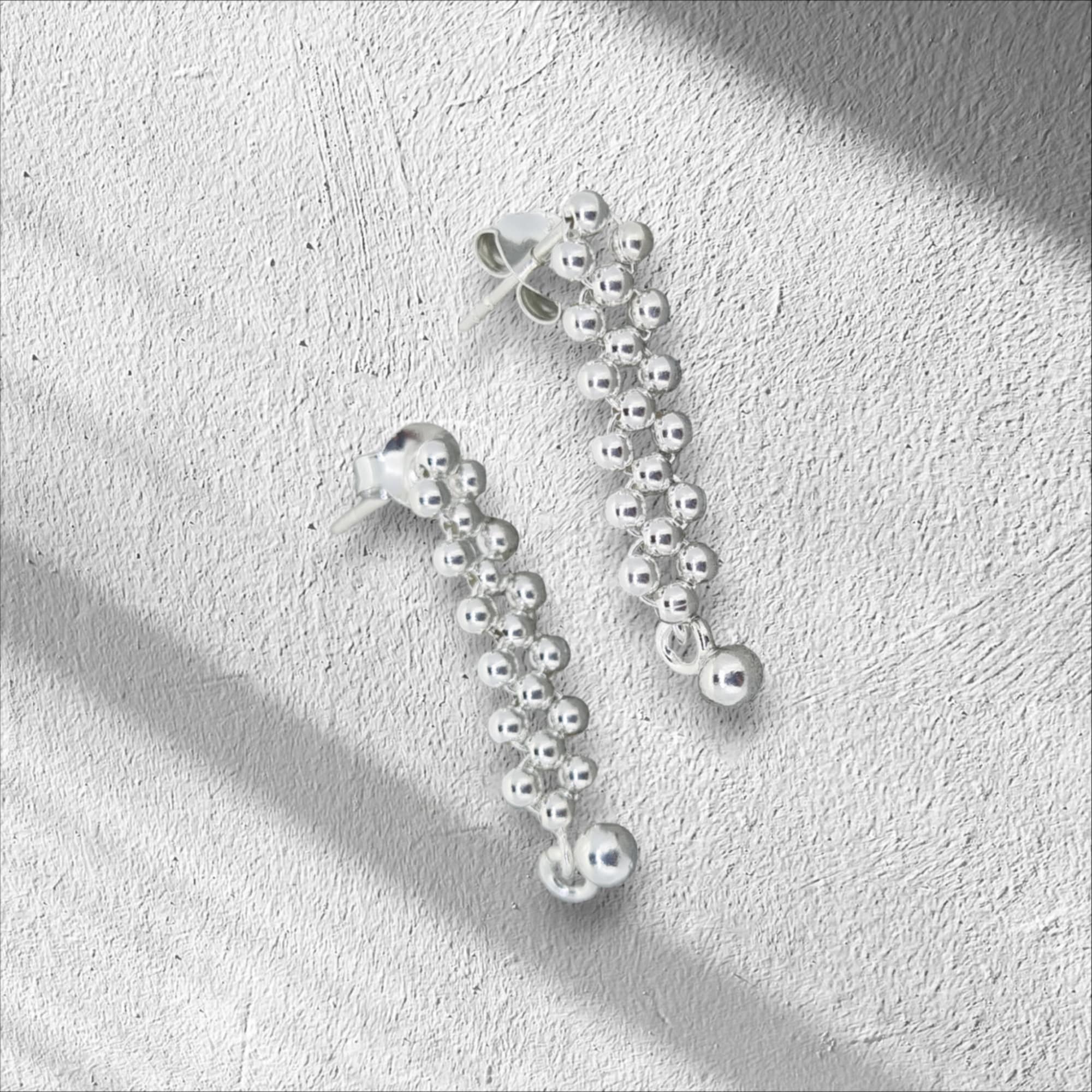 Sterling silver plaited drop stud earrings, adorned with petite balls that sway with every movement.