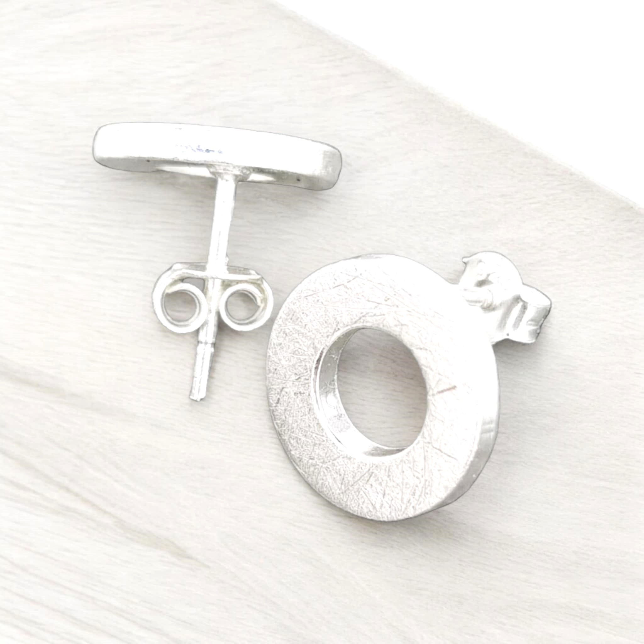 Sterling silver these circle-shaped studs exude a subtle matte finish that lends them a contemporary appeal