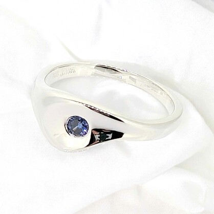 This sterling silver ring with a petite tanzanite zirconia glimmering in a tranquil sterling silver pond