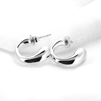Sterling silver opened sleeper earrings have a stretched look tapering gracefully from a thinner top to a wider base