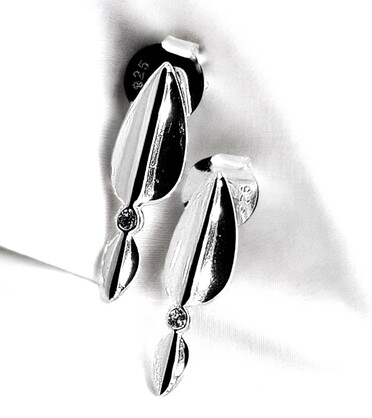 Sterling silver stud earrings feature two folded curved strips of silver that meet at the center with a sparkling white zirconia gem
