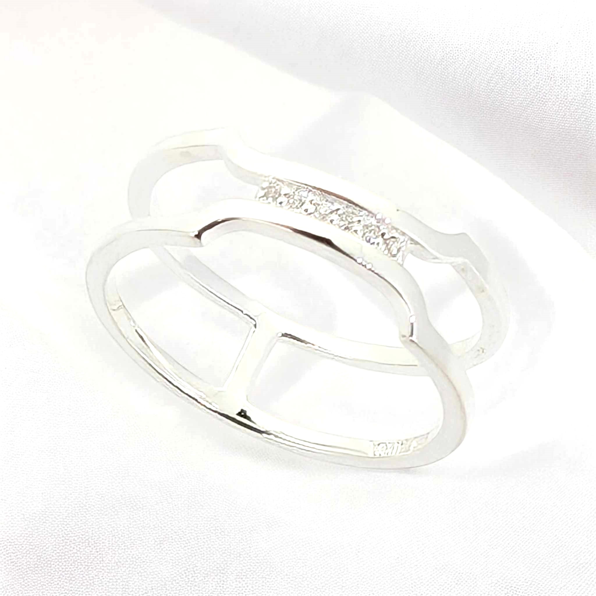 7 A sleek sterling silver band with a delicate cluster of petite white zirconia stones that come together gracefully at the top